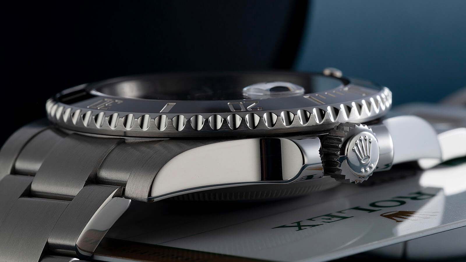 side of a rolex watch showing logo Rolex Submariner Date